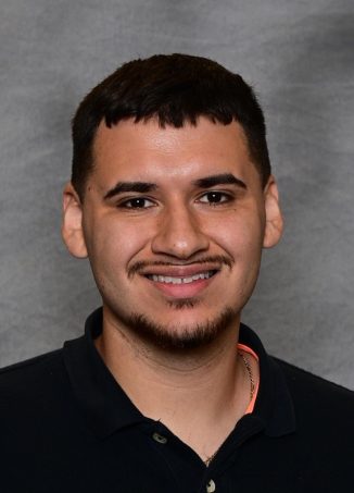 Smiling young man in black polo shirt, portrait photo.