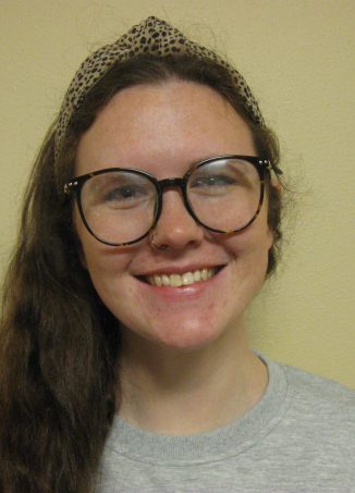 Smiling student wearing glasses and knit headband