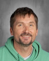Man wearing green shirt smiling at camera portrait