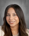 Smiling woman with long dark hair, professional headshot photo.