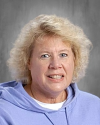 Smiling woman with blonde hair wearing lavender sweater