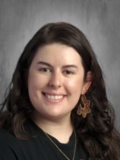 Smiling student with long dark hair wearing black shirt